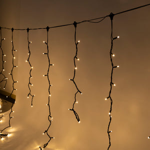 LED Icicle Fairy Lights - Golden Warm White, 10M with 1m drops 24VDC, BLACK CABLE, 30cm string spacing, 10cm ledspacing.  incl. transformer