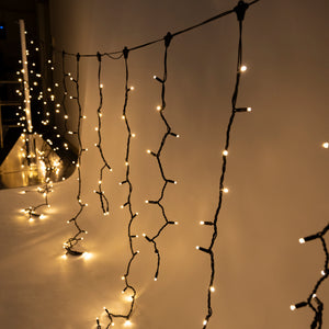 LED Icicle Fairy Lights - Golden Warm White, 10M with 1m drops 24VDC, BLACK CABLE, 30cm string spacing, 10cm ledspacing.  incl. transformer